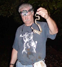 Henderson with a tree boa, looking thrilled